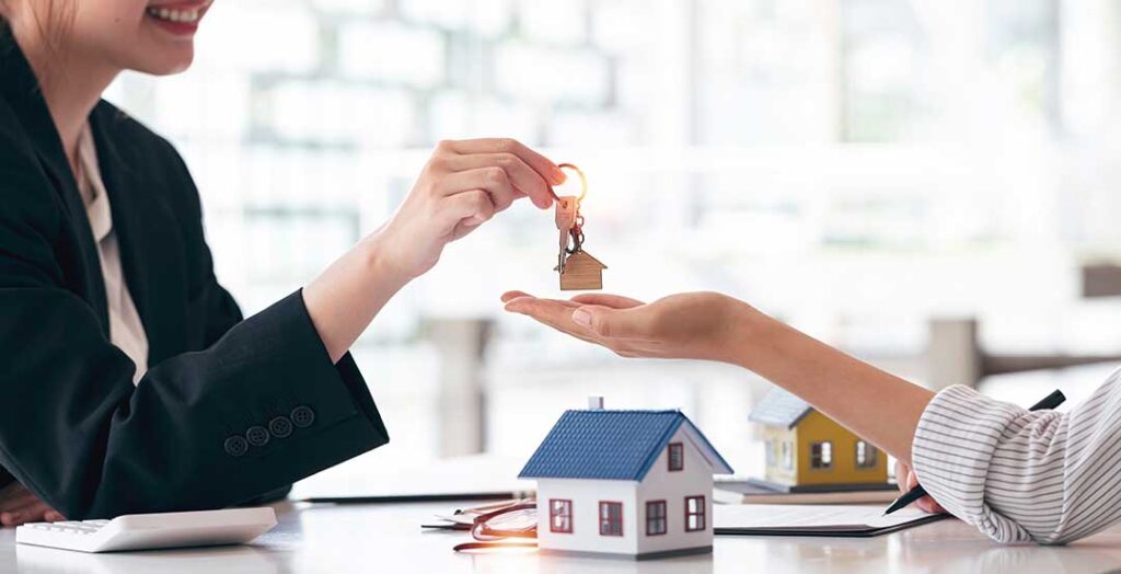 A local real estate agent discussing documents with a client in a comfortable home setting.